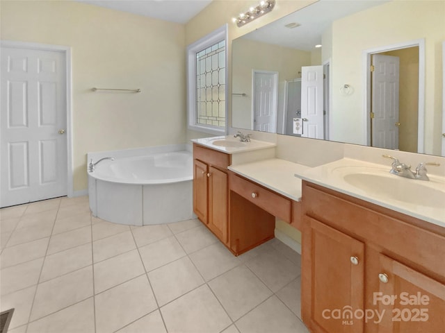 full bath featuring a bath, double vanity, a sink, and tile patterned floors