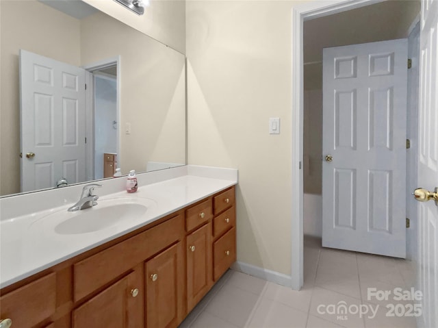 bathroom with tile patterned flooring, vanity, and baseboards