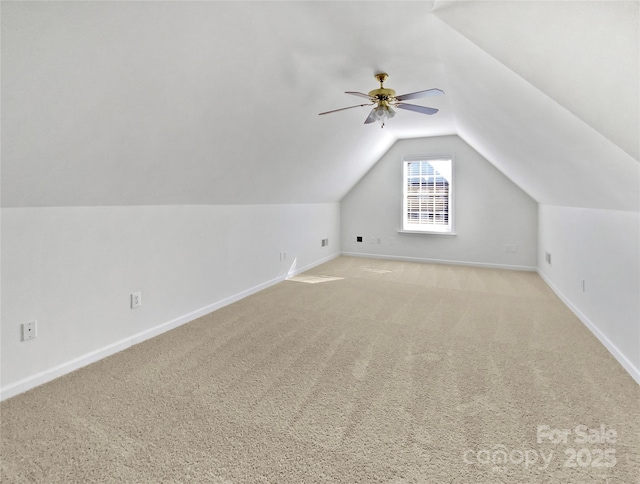 additional living space featuring vaulted ceiling, ceiling fan, light carpet, and baseboards