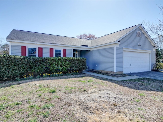 ranch-style house with driveway and an attached garage