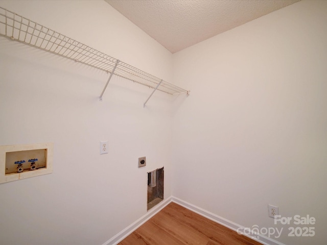 washroom with laundry area, baseboards, light wood-style flooring, hookup for a washing machine, and hookup for an electric dryer