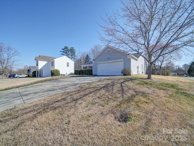 view of property exterior featuring a garage and driveway