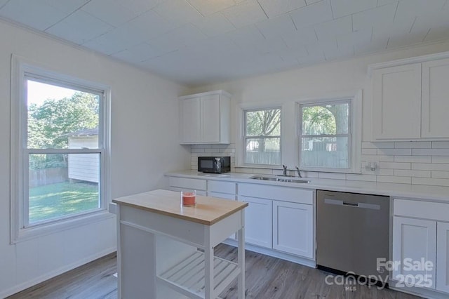 kitchen featuring a sink, a wealth of natural light, black microwave, and stainless steel dishwasher