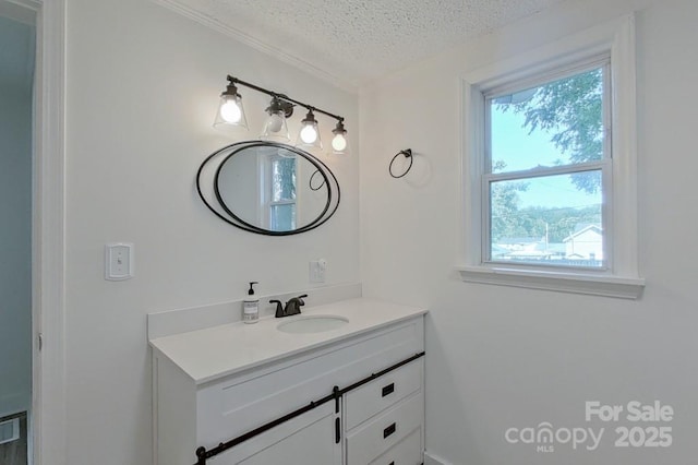 bathroom with a textured ceiling and vanity