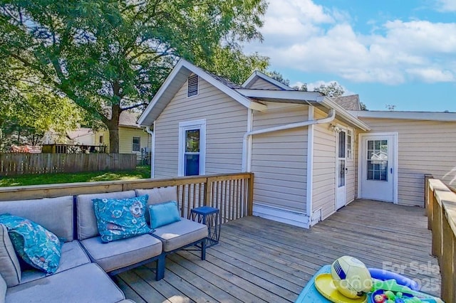 wooden deck featuring outdoor lounge area and fence