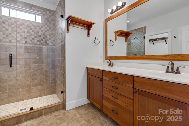 bathroom with double vanity, a stall shower, tile patterned floors, and a sink