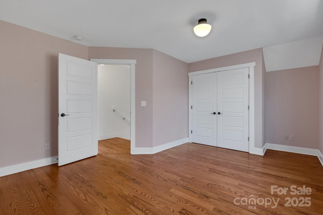 unfurnished bedroom featuring baseboards and wood finished floors