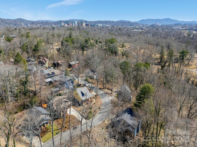 drone / aerial view with a mountain view and a view of trees