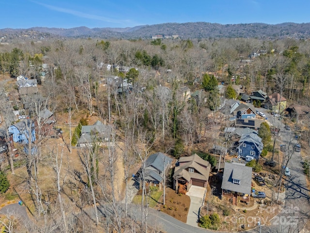 bird's eye view featuring a view of trees, a mountain view, and a residential view