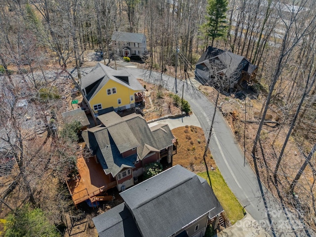 birds eye view of property featuring a view of trees