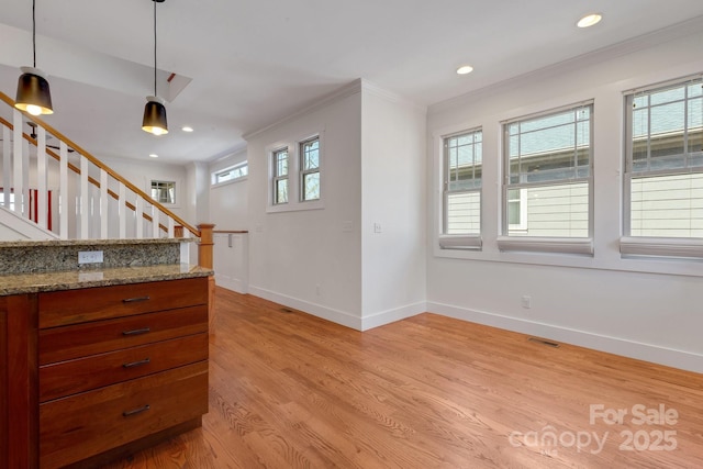 interior space with visible vents, crown molding, light wood finished floors, baseboards, and stairs