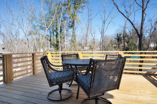 wooden deck with outdoor dining space