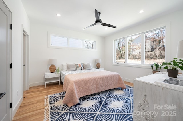 bedroom with light wood-type flooring, ceiling fan, baseboards, and recessed lighting