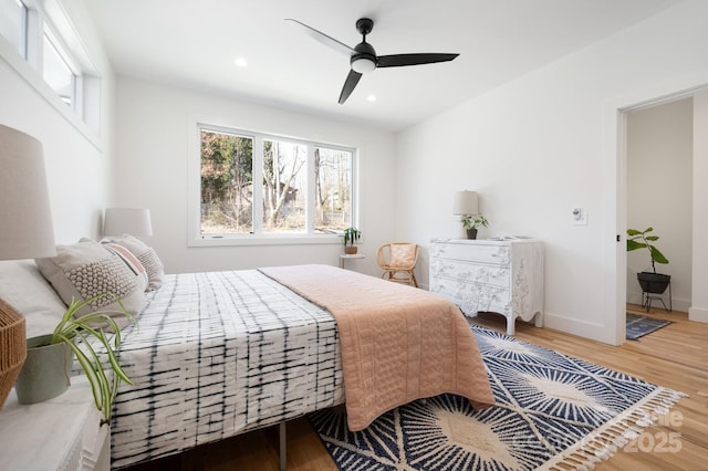 bedroom featuring a ceiling fan, recessed lighting, baseboards, and wood finished floors