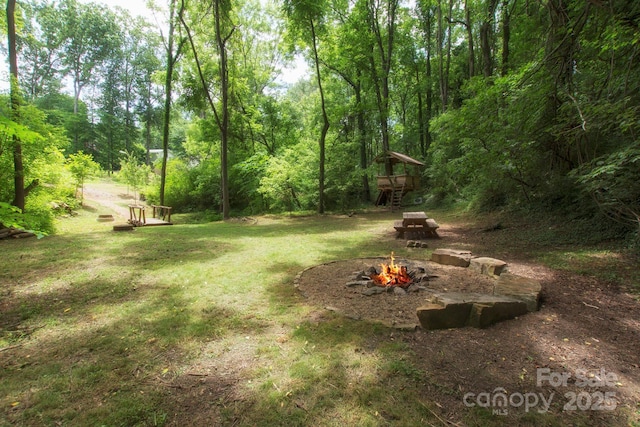 view of yard with a fire pit