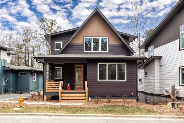 view of front of property featuring a porch and a shingled roof