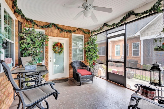 sunroom / solarium with a ceiling fan