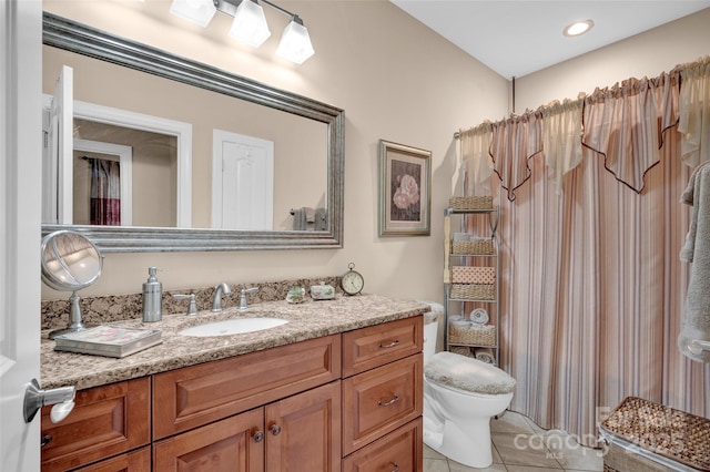 bathroom featuring tile patterned floors, toilet, and vanity