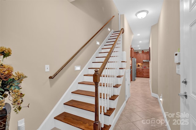 staircase featuring tile patterned floors, baseboards, and recessed lighting