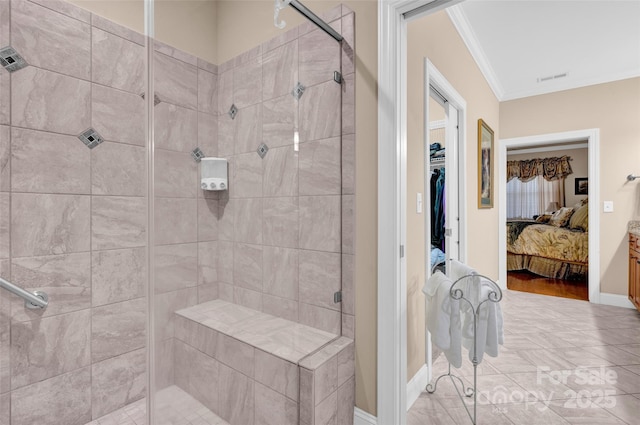 ensuite bathroom with visible vents, crown molding, baseboards, a stall shower, and ensuite bath