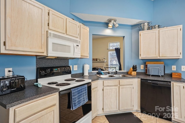 kitchen with white microwave, a sink, light brown cabinetry, range with electric cooktop, and black dishwasher