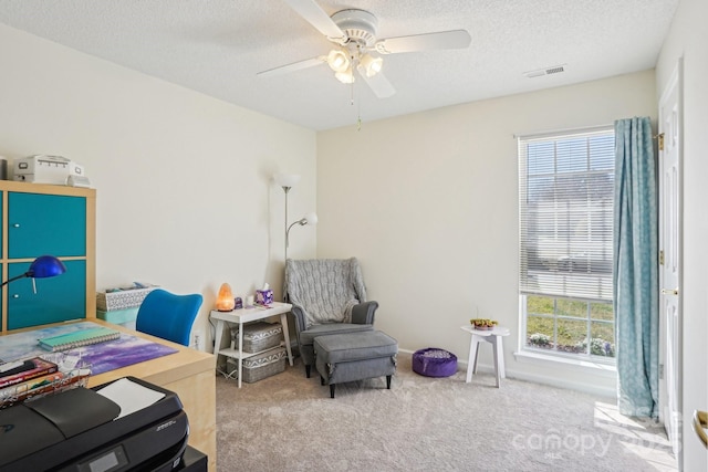 bedroom featuring visible vents, baseboards, ceiling fan, carpet, and a textured ceiling