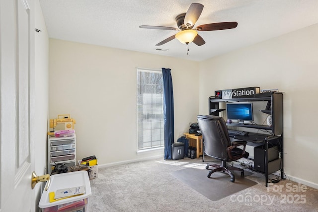 carpeted home office with visible vents, ceiling fan, a textured ceiling, and baseboards