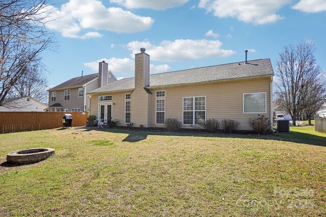 back of house with french doors, a fire pit, a yard, and fence