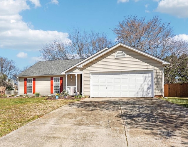 ranch-style home with an attached garage, fence, driveway, and a front lawn