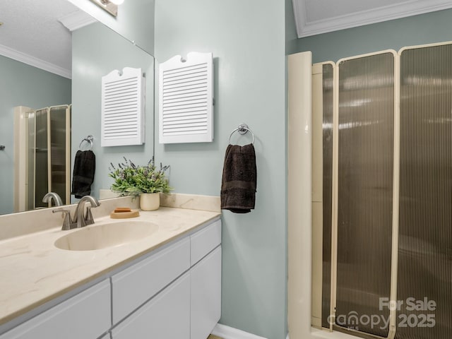 bathroom with vanity, a shower with door, and ornamental molding