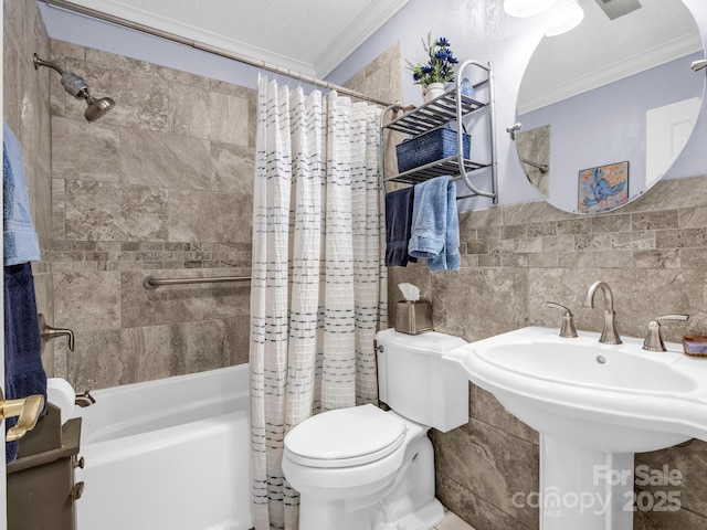 bathroom with toilet, ornamental molding, shower / bath combo, a textured ceiling, and tile walls