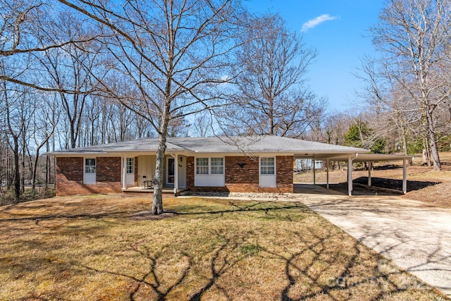 ranch-style house featuring brick siding, an attached carport, concrete driveway, and a front yard