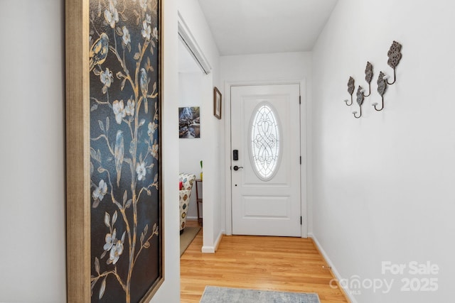 entryway featuring light wood-style floors and baseboards