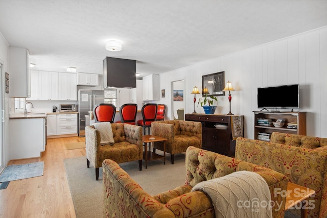 living room with light wood finished floors and a toaster