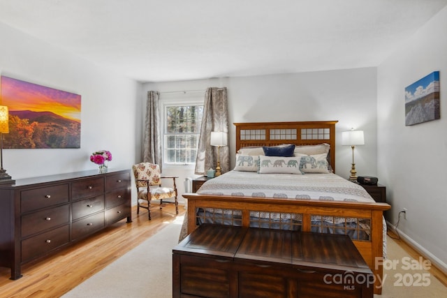 bedroom with light wood-style floors and baseboards