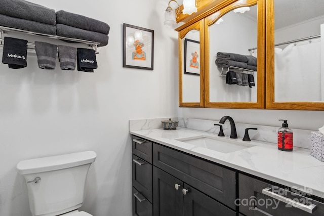 bathroom featuring toilet and vanity