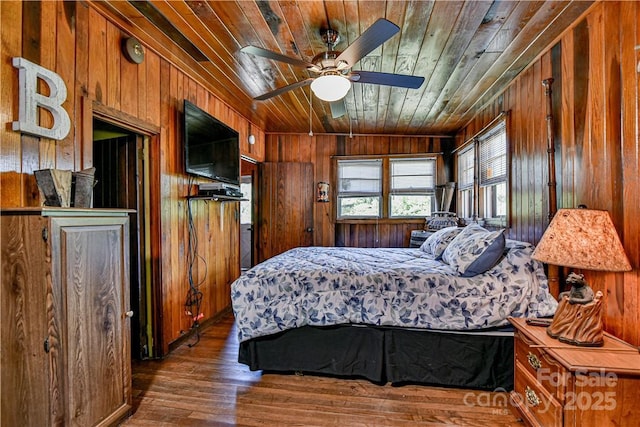 bedroom featuring wooden walls, wood ceiling, and wood finished floors