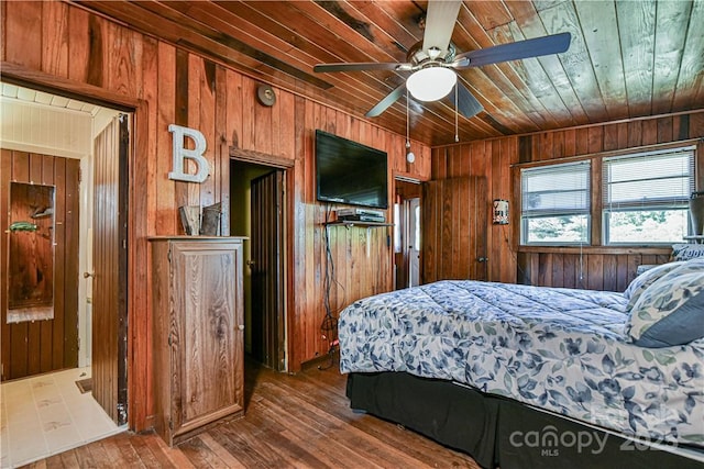 bedroom featuring wooden ceiling, hardwood / wood-style flooring, and wood walls