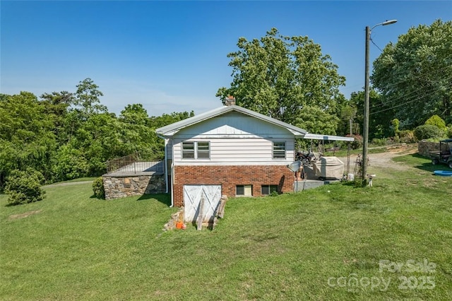 view of home's exterior with a yard and brick siding