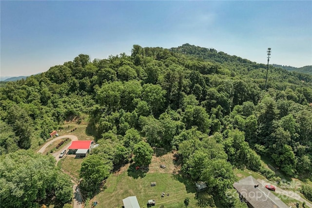 drone / aerial view featuring a wooded view
