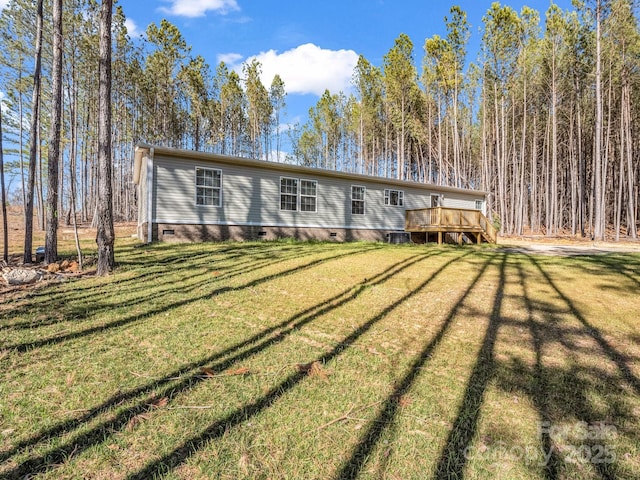 view of front of property with crawl space, a deck, and a front yard