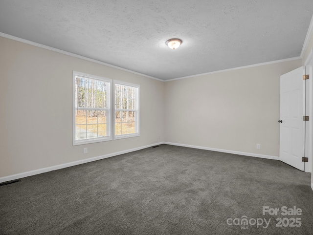 empty room featuring dark colored carpet, visible vents, ornamental molding, a textured ceiling, and baseboards