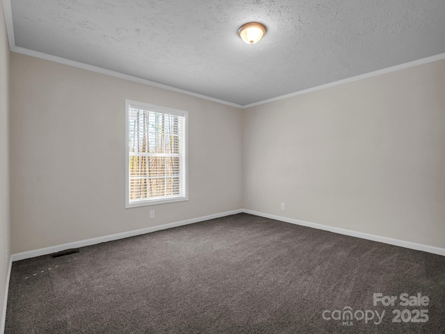 carpeted spare room featuring a textured ceiling and ornamental molding