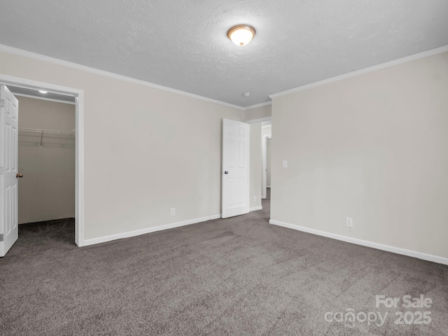 unfurnished bedroom with carpet floors, crown molding, a textured ceiling, and baseboards