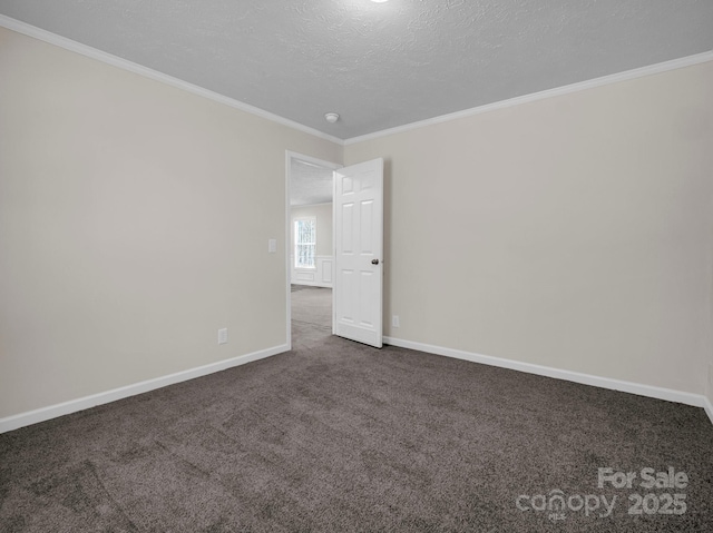 unfurnished room with ornamental molding, dark carpet, a textured ceiling, and baseboards