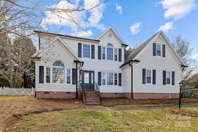 traditional-style home with a front lawn, crawl space, and fence