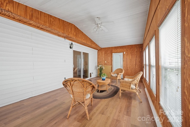 sunroom / solarium with a ceiling fan and vaulted ceiling