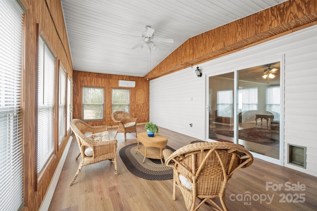 sunroom featuring lofted ceiling, ceiling fan, and a wall unit AC