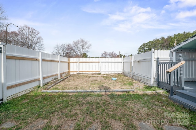 view of yard with a garden and a fenced backyard