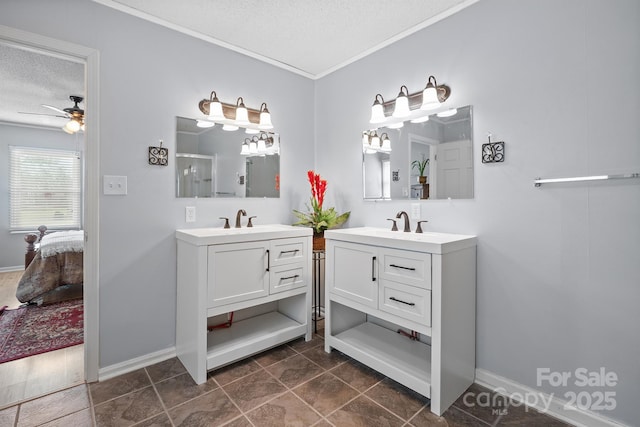 ensuite bathroom featuring a textured ceiling, two vanities, ensuite bathroom, and a sink